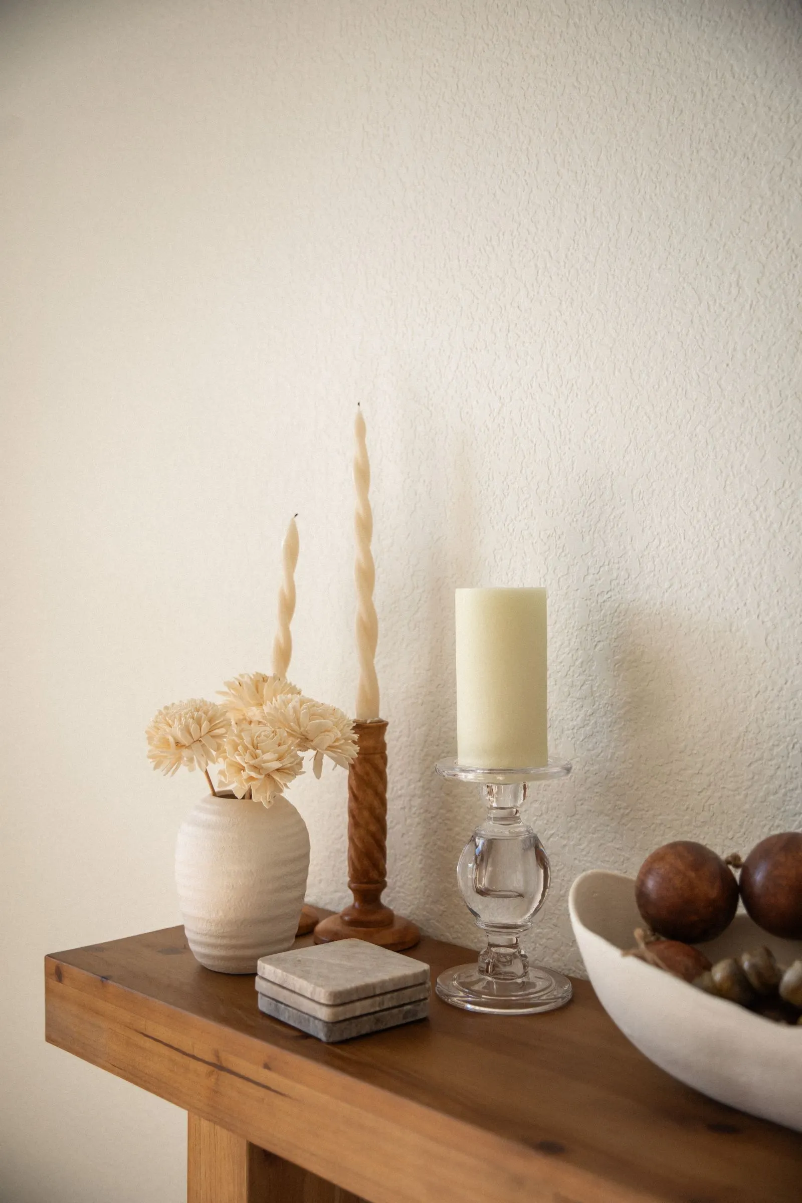 Candles and dried flowers on a wooden console
