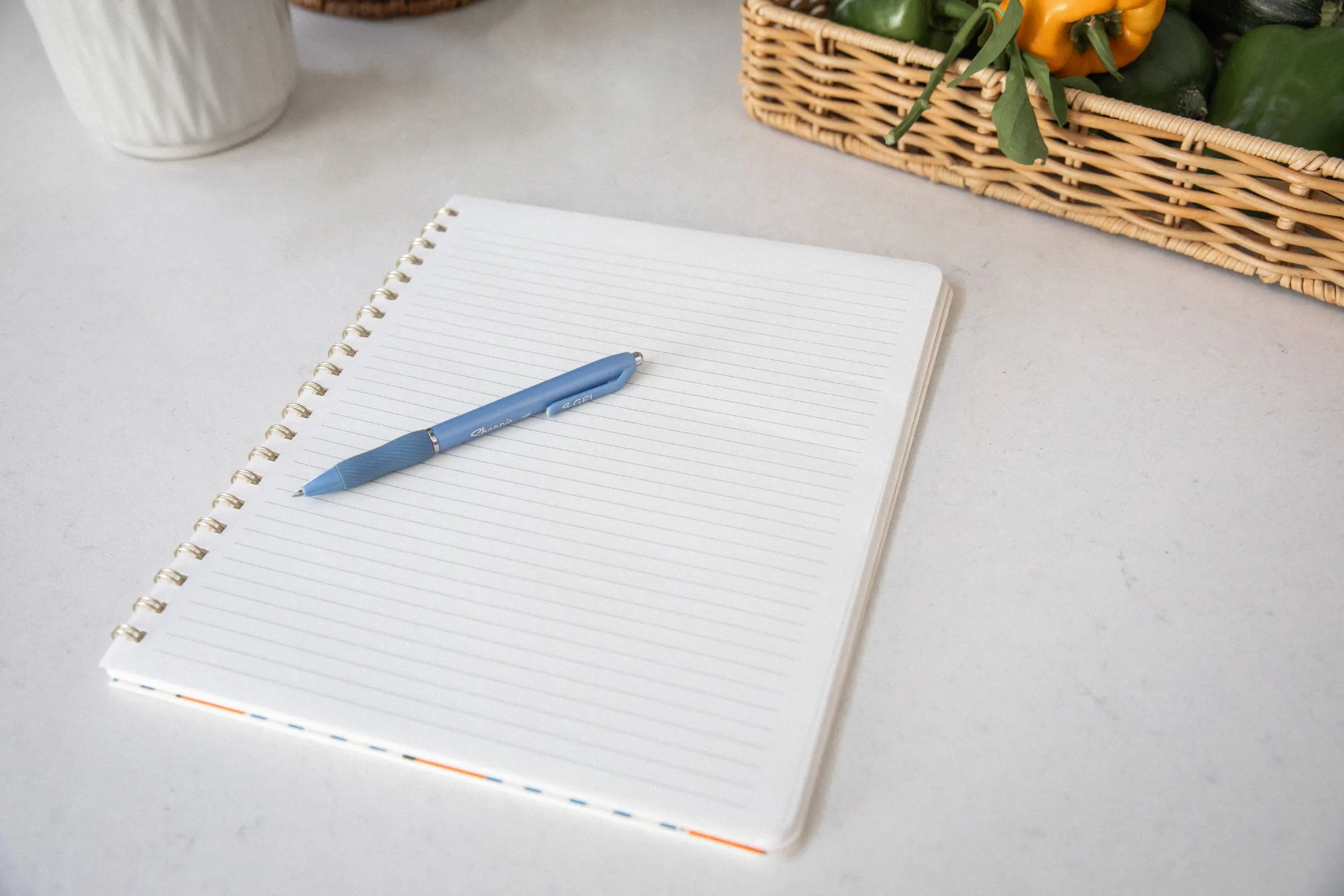 An open notebook and pen on a counter